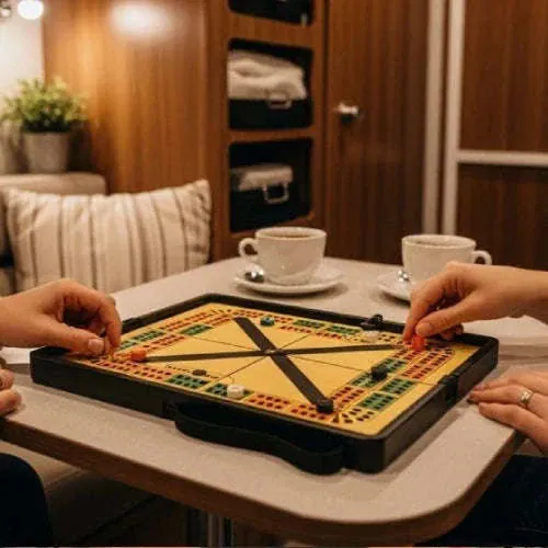 Couple playing a cribbage board game at an RV dinette