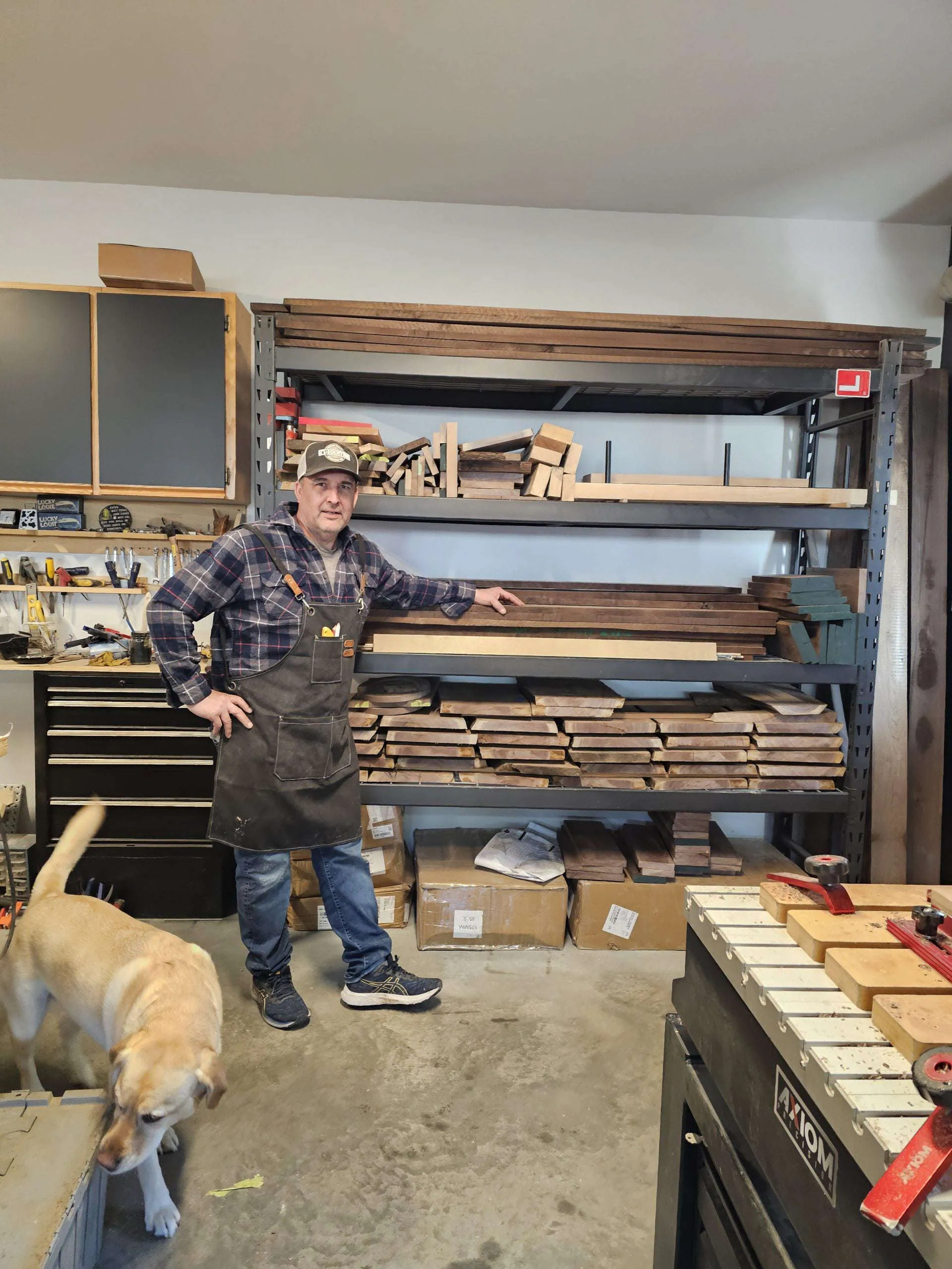 Our founder beside a rack of walnut lumber in the workshop